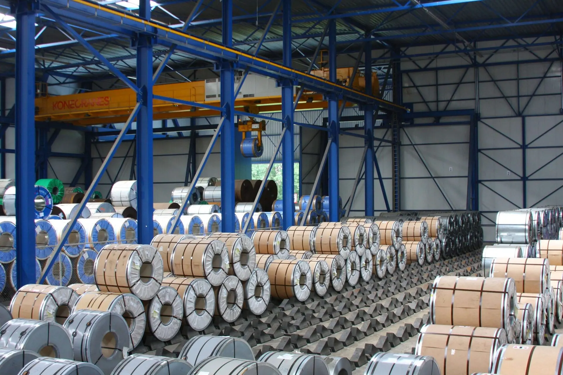 Steel coils under the overhead cranes in a Maasterminal warehouse